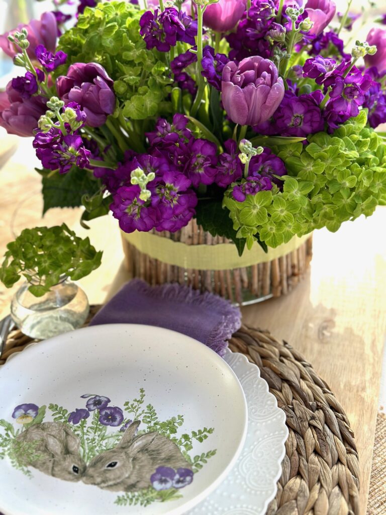 easter centerpiece in green and purple with a place setting.