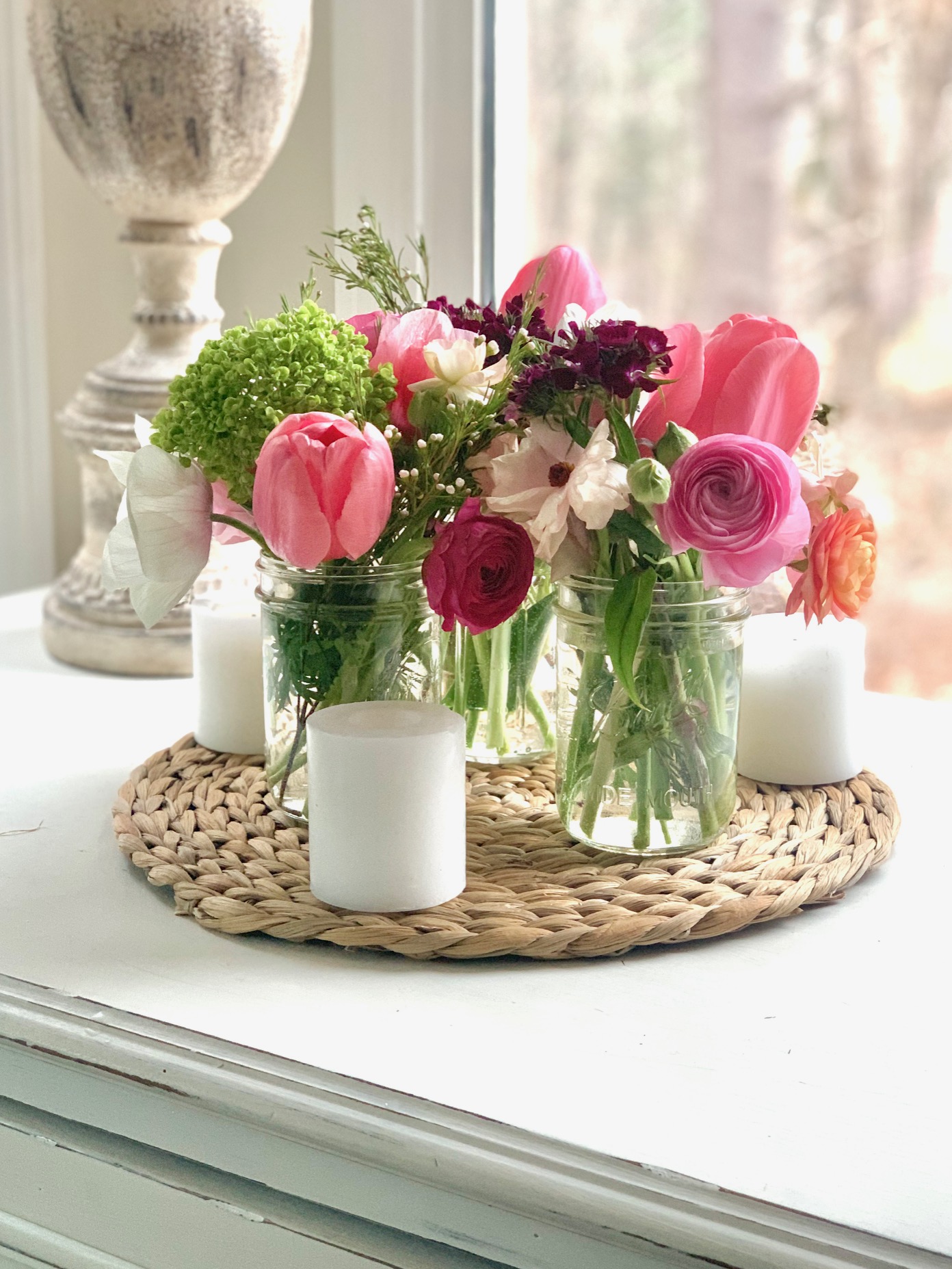mason jars filed with spring flowers for a clustered Easter centerpiece.