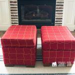Two red windowpane plaid ottomans before makeover.