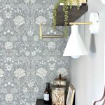 floral wallpaper, lights, folding table and laundry supplies.