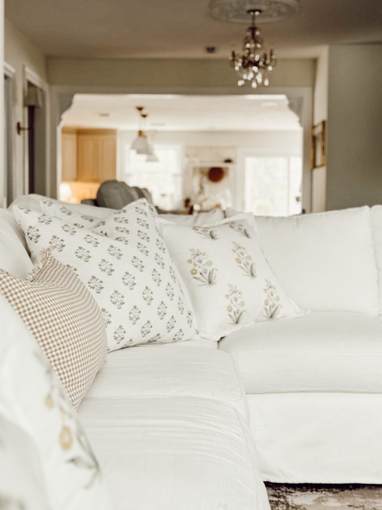 Decorative pillows on a white couch in a country cottage farmhouse living room.
