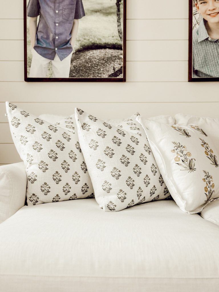 Family room throw pillows on a traditional white couch for extra coziness.