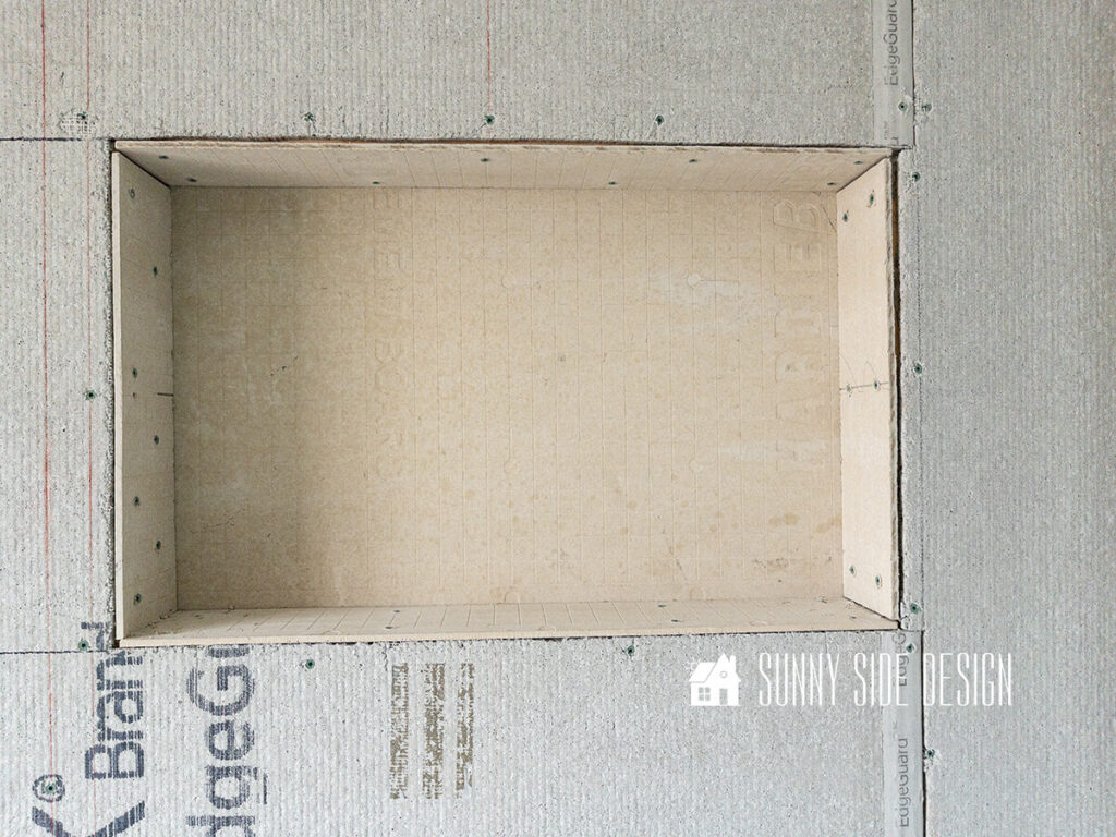 Shower niche area covered in cement backer board.