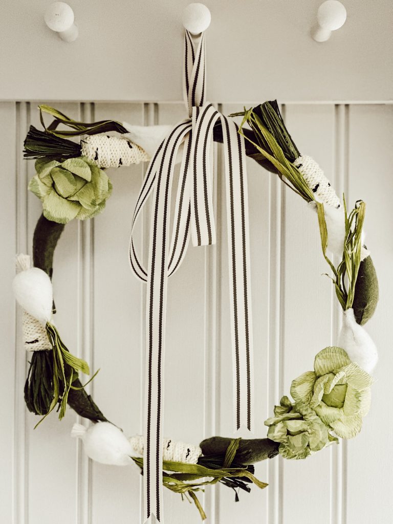 Spring wreath hanging in a cottage farmhouse kitchen for rustic charm.